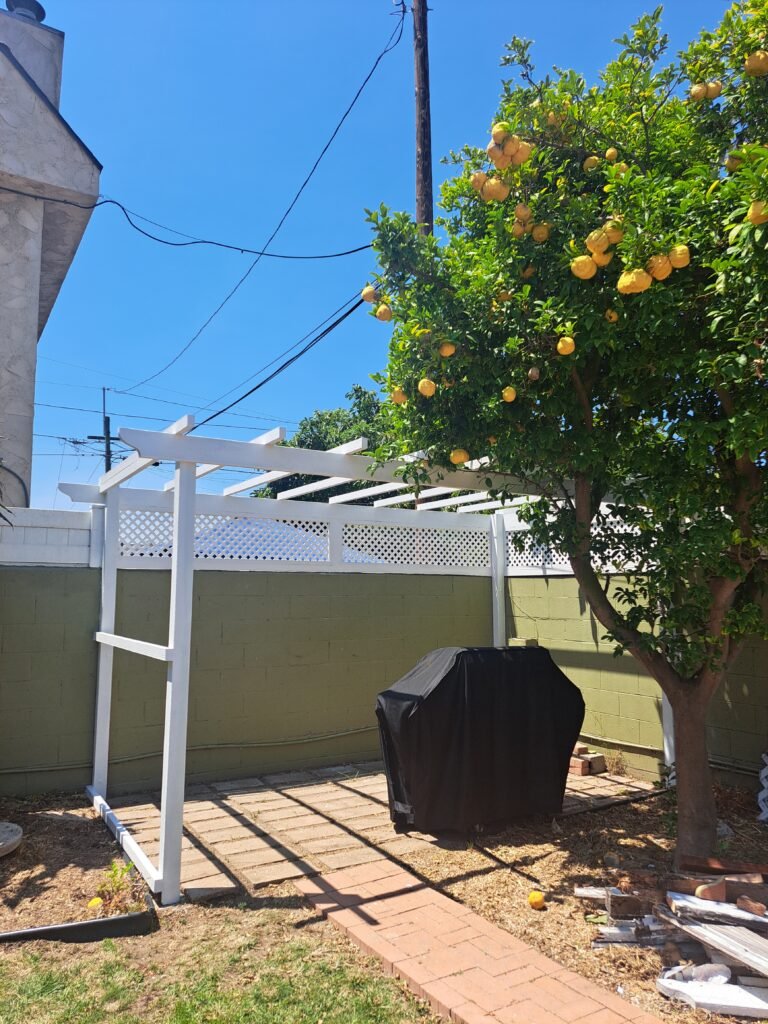 Custom wood pergola built over an outdoor barbecue area.
