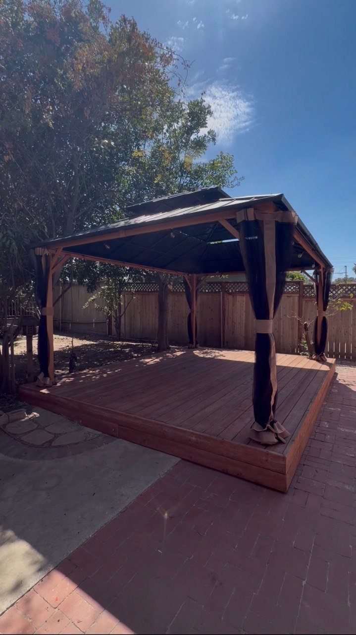 Completed wood deck with a covered gazebo and outdoor seating area.